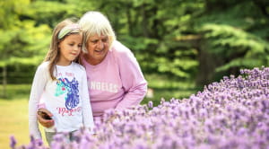 An older woman and a child looking at some plants